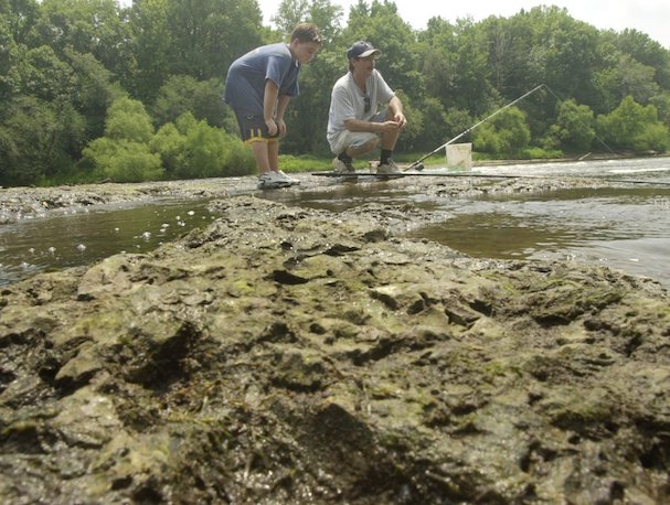Photo showing two men fishing along the shrinking Pee Dee River